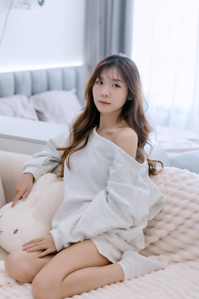 Cozy indoor portrait of a young woman relaxing in a bright, modern room.